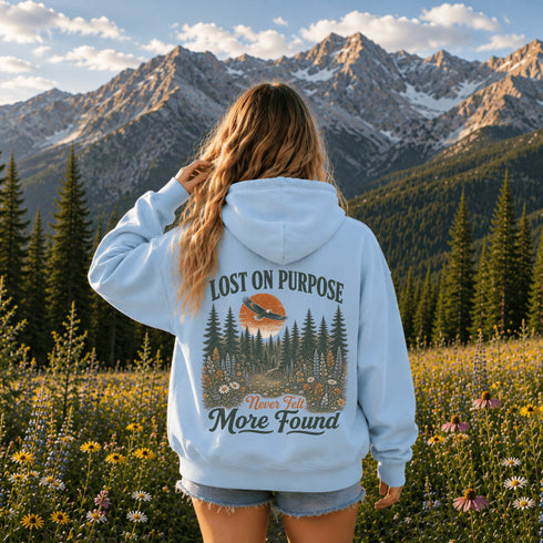 Vintage outdoor hoodie featuring a matching left chest graphic and a large back design inspired by hiking, forests, mountains, and adventure on a premium unisex hoodie displayed in an outdoor lifestyle setting.