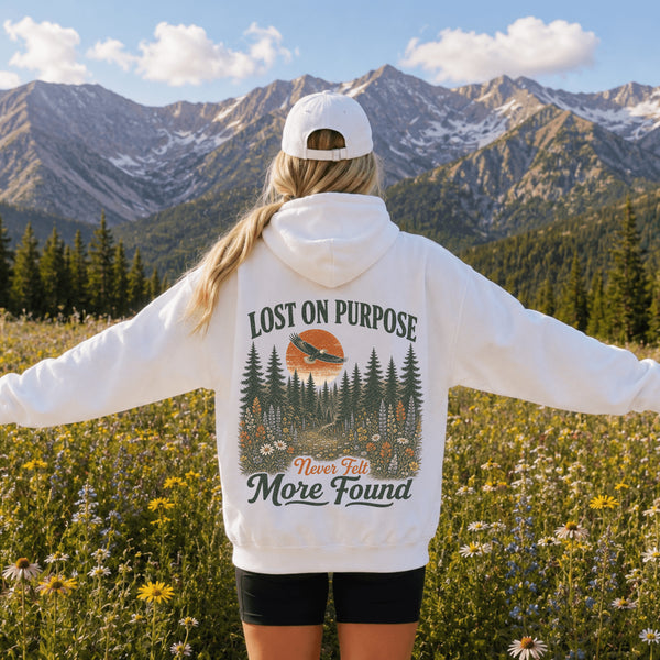 Vintage outdoor hoodie featuring a matching left chest graphic and a large back design inspired by hiking, forests, mountains, and adventure on a premium unisex hoodie displayed in an outdoor lifestyle setting.