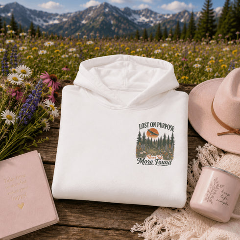 Vintage outdoor hoodie featuring a matching left chest graphic and a large back design inspired by hiking, forests, mountains, and adventure on a premium unisex hoodie displayed in an outdoor lifestyle setting.
