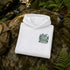 A folded white hoodie is placed on a mossy rock outdoors, with a small chest print reading “Lost in the Forest” in green and tan tones. A backpack is partly visible on the left, and a bottle is on the right, with ferns and a forest setting in the background.