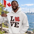 Love Canada hoodie featuring bold black lettering and red Canadian maple leaf graphic on a unisex sweatshirt