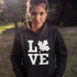 Canada LOVE hoodie with Canadian maple leaf graphic on a black unisex sweatshirt