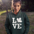 Canada LOVE hoodie with Canadian maple leaf graphic on a forest green unisex sweatshirt