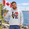 Love Canada hoodie featuring bold black lettering and red Canadian maple leaf graphic on a unisex sweatshirt