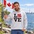 Love Canada hoodie featuring bold black lettering and red Canadian maple leaf graphic on a unisex sweatshirt