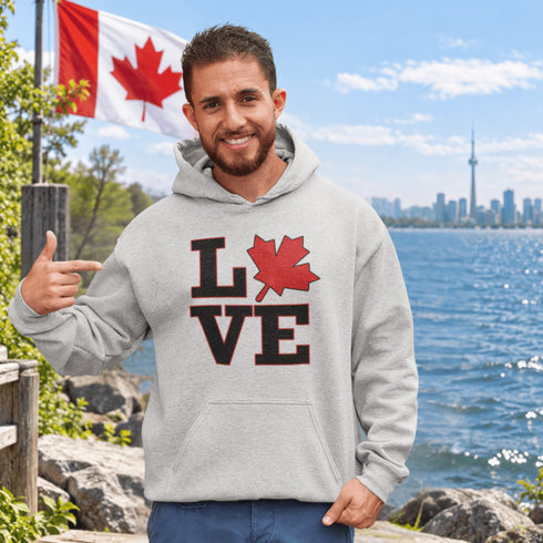 Love Canada hoodie featuring bold black lettering and red Canadian maple leaf graphic on a unisex sweatshirt