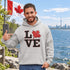 Love Canada hoodie featuring bold black lettering and red Canadian maple leaf graphic on a unisex sweatshirt