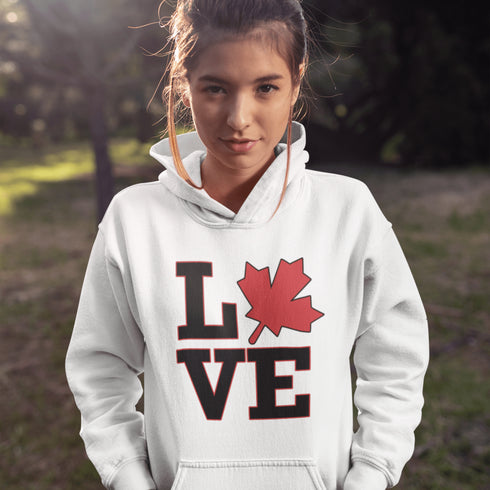 Love Canada hoodie featuring bold black lettering and red Canadian maple leaf graphic on a unisex sweatshirt