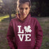 Canada LOVE hoodie with Canadian maple leaf graphic on a maroon unisex sweatshirt