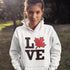 Love Canada hoodie featuring bold black lettering and red Canadian maple leaf graphic on a unisex sweatshirt