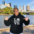 Canada LOVE hoodie with Canadian maple leaf graphic on a black unisex sweatshirt