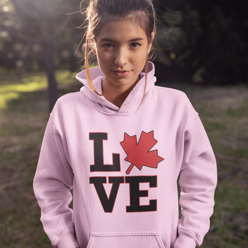 Love Canada hoodie featuring bold black lettering and red Canadian maple leaf graphic on a unisex sweatshirt