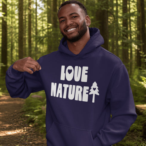 Man wearing a blue hoodie with 'LOVE NATURE' text in a forest setting