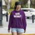 Person wearing a purple hoodie with 'LOVE NATURE' text outdoors.
