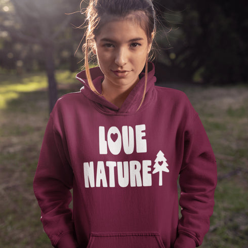 Person wearing a maroon hoodie with 'Love Nature' text in a natural setting