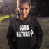 Woman wearing a black hoodie with 'Love Nature' text and a tree graphic outdoors.