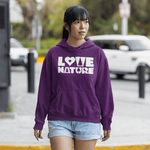 Woman wearing a purple hoodie with 'LOVE NATURE' text on a street.