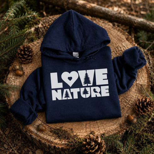 Navy blue hoodie with 'Love Nature' text on a wooden stump with pinecones and branches.