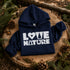 Navy blue hoodie with 'Love Nature' text on a wooden stump with pinecones and branches.