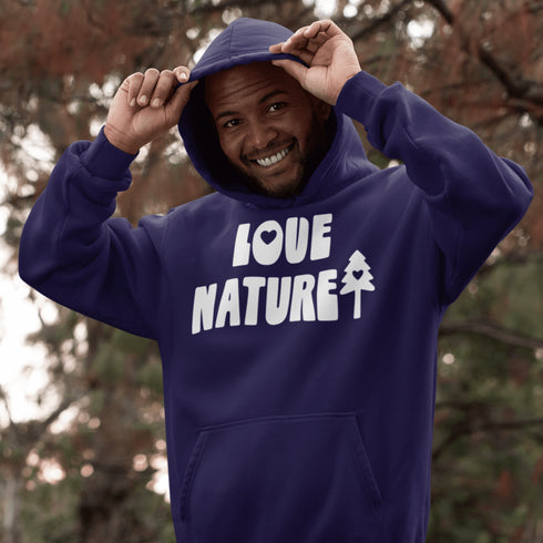 Person wearing a purple hoodie with 'LOVE NATURE' text and a tree graphic, standing outdoors.
