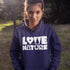 Person wearing a navy hoodie with 'Love Nature' text in a natural setting