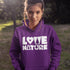 Person wearing a purple hoodie with 'LOVE NATURE' text in a natural setting
