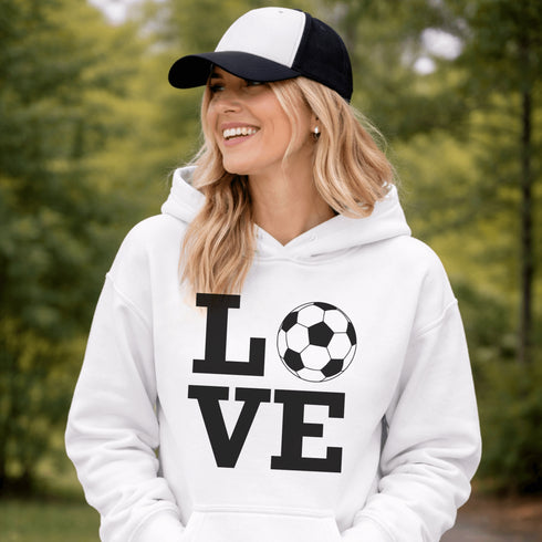Hoodie with bold LOVE design featuring a soccer ball replacing the O, worn by woman holding coffee cup outdoors