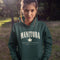 Manitoba Rooted in the Heartland hoodie with maple leaf and vintage collegiate lettering on a unisex Gildan sweatshirt