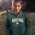 Manitoba Rooted in the Heartland hoodie with maple leaf and vintage collegiate lettering on a unisex Gildan sweatshirt