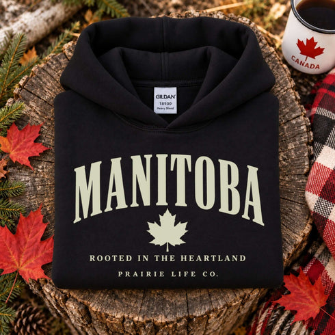 Manitoba Rooted in the Heartland hoodie with maple leaf and vintage collegiate lettering on a unisex Gildan sweatshirt
