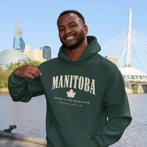 Manitoba Rooted in the Heartland hoodie with maple leaf and vintage collegiate lettering on a unisex Gildan sweatshirt