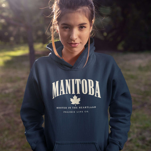 Manitoba Rooted in the Heartland hoodie with maple leaf and vintage collegiate lettering on a unisex Gildan sweatshirt