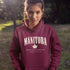 Manitoba Rooted in the Heartland hoodie with maple leaf and vintage collegiate lettering on a unisex Gildan sweatshirt