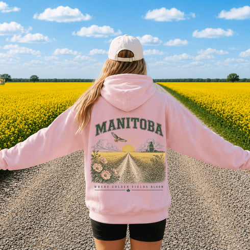 Vintage-inspired Manitoba prairie hoodie featuring a matching left chest design and oversized back graphic displayed on a unisex hoodie lifestyle mockup in an outdoor prairie setting. Available in multiple hoodie colors.