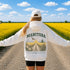 Vintage-inspired Manitoba prairie hoodie featuring a matching left chest design and oversized back graphic displayed on a unisex hoodie lifestyle mockup in an outdoor prairie setting. Available in multiple hoodie colors.