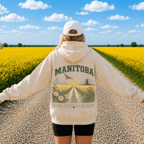 Vintage-inspired Manitoba prairie hoodie featuring a matching left chest design and oversized back graphic displayed on a unisex hoodie lifestyle mockup in an outdoor prairie setting. Available in multiple hoodie colors.