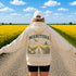 Vintage-inspired Manitoba prairie hoodie featuring a matching left chest design and oversized back graphic displayed on a unisex hoodie lifestyle mockup in an outdoor prairie setting. Available in multiple hoodie colors.