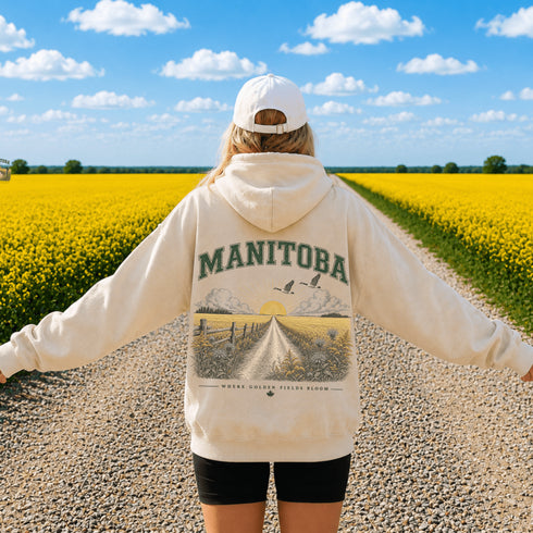 Vintage-inspired Manitoba prairie hoodie featuring a matching left chest design and oversized back graphic displayed on a unisex hoodie lifestyle mockup in an outdoor prairie setting. Available in multiple hoodie colors.