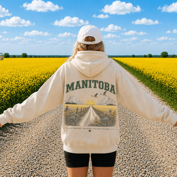 Vintage-inspired Manitoba prairie hoodie featuring a matching left chest design and oversized back graphic displayed on a unisex hoodie lifestyle mockup in an outdoor prairie setting. Available in multiple hoodie colors.