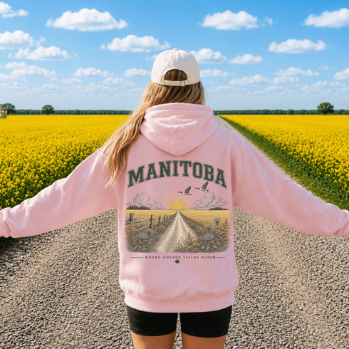 Vintage-inspired Manitoba prairie hoodie featuring a matching left chest design and oversized back graphic displayed on a unisex hoodie lifestyle mockup in an outdoor prairie setting. Available in multiple hoodie colors.