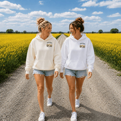 Vintage-inspired Manitoba prairie hoodie featuring a matching left chest design and oversized back graphic displayed on a unisex hoodie lifestyle mockup in an outdoor prairie setting. Available in multiple hoodie colors.