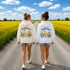 Vintage-inspired Manitoba prairie hoodie featuring a matching left chest design and oversized back graphic displayed on a unisex hoodie lifestyle mockup in an outdoor prairie setting. Available in multiple hoodie colors.