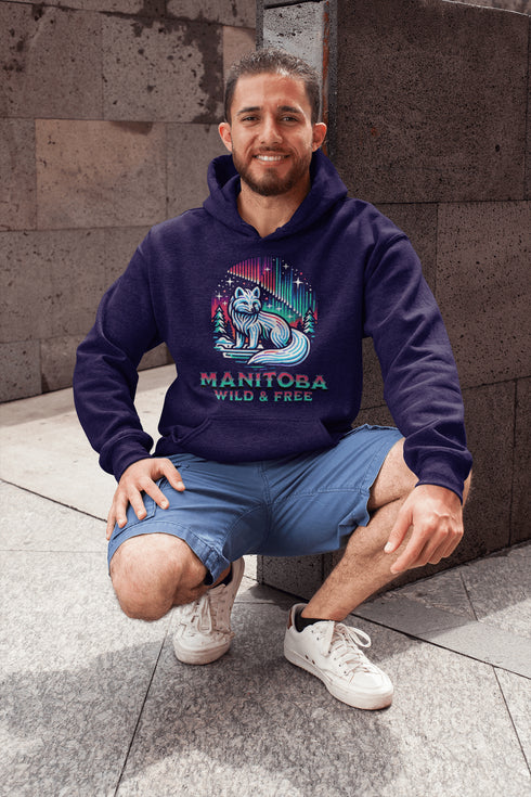 Embrace the beauty of the North with our Manitoba - Wild & Free Hoodie, featuring a stunning graphic of an arctic fox beneath the shimmering northern lights.
