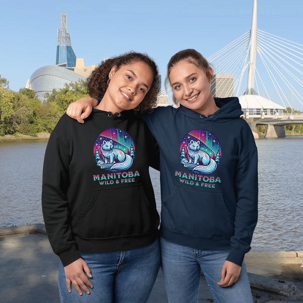Embrace the beauty of the North with our Manitoba - Wild & Free Hoodie, featuring a stunning graphic of an arctic fox beneath the shimmering northern lights.