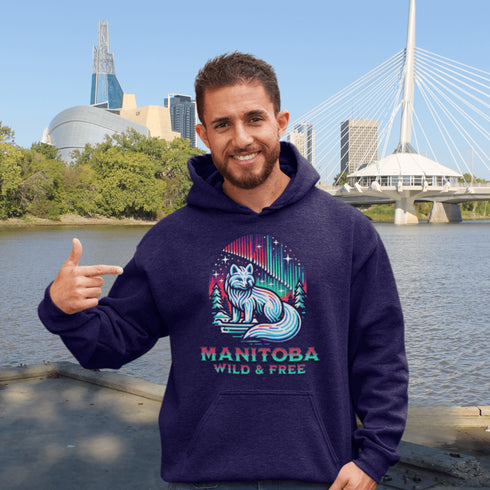 Embrace the beauty of the North with our Manitoba - Wild & Free Hoodie, featuring a stunning graphic of an arctic fox beneath the shimmering northern lights.