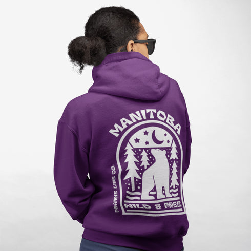 Featuring a bold bear graphic surrounded by pine trees and a crescent moon, this hoodie captures everything we love about Manitoba’s wild landscape.