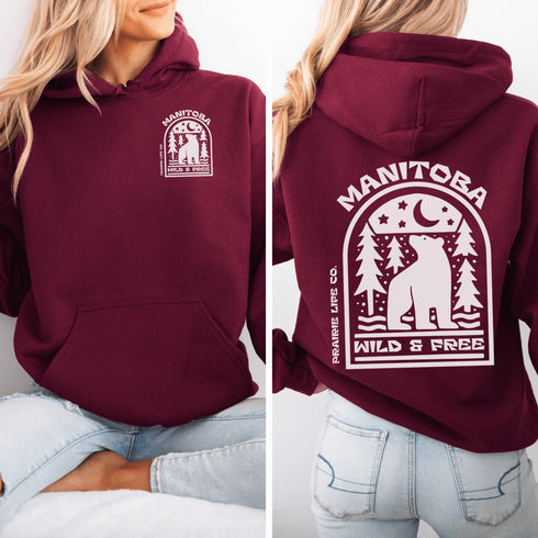 Featuring a bold bear graphic surrounded by pine trees and a crescent moon, this hoodie captures everything we love about Manitoba’s wild landscape.