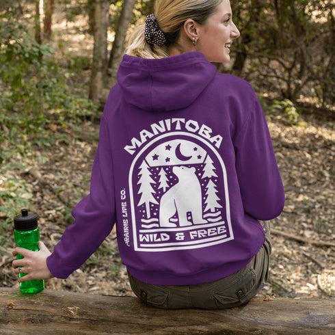 Featuring a bold bear graphic surrounded by pine trees and a crescent moon, this hoodie captures everything we love about Manitoba’s wild landscape.