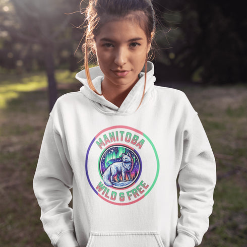 Unleash your wild side with our Manitoba – Wild & Free hoodie, featuring an enchanting graphic of an arctic fox beneath the dazzling northern lights.