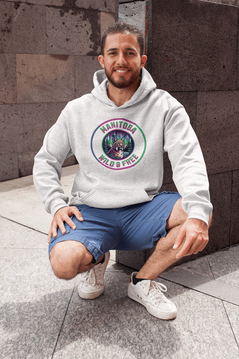 Step into the wild with our Manitoba – Wild & Free hoodie, featuring a striking graphic of a lynx under the glow of the northern lights.